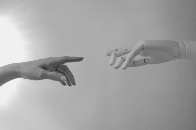 Human hand and robot hand representing AI automation